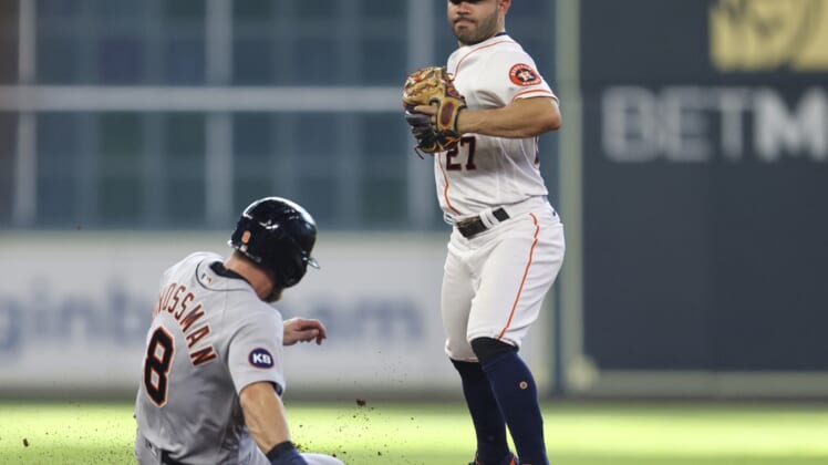 May 7, 2022; Houston, Texas, USA; Houston Astros second baseman Jose Altuve (27) forces out Detroit Tigers right fielder Robbie Grossman (8)  in the seventh  inning at Minute Maid Park. Mandatory Credit: Thomas Shea-USA TODAY Sports