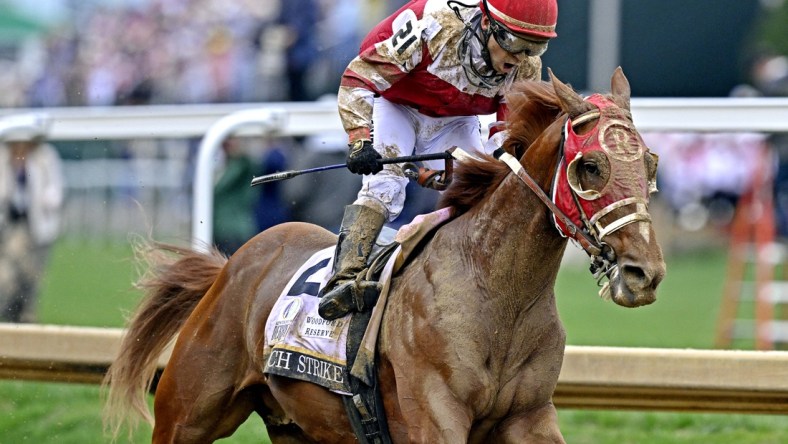 May 7, 2022; Louisville, KY, USA; Sonny Leon aboard Rich Strike celebrates winning the 148th running of the Kentucky Derby at Churchill Downs. Mandatory Credit: Jamie Rhodes-USA TODAY Sports