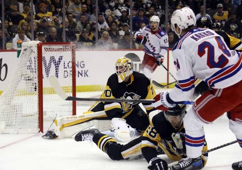 May 7, 2022; Pittsburgh, Pennsylvania, USA;  New York Rangers right wing Kaapo Kakko (24) scores a goal against Pittsburgh Penguins goaltender Louis Domingue (70) during the first period in game three of the first round of the 2022 Stanley Cup Playoffs at PPG Paints Arena. Mandatory Credit: Charles LeClaire-USA TODAY Sports