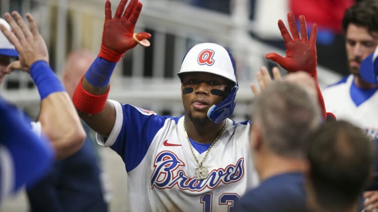 May 7, 2022; Atlanta, Georgia, USA; Atlanta Braves right fielder Ronald Acuna Jr. (13) celebrates with teammates after hitting a home run against the Milwaukee Brewers in the fifth inning at Truist Park. Mandatory Credit: Brett Davis-USA TODAY Sports