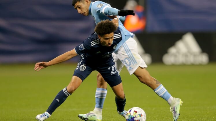 May 7, 2022; New York, NY, New York, NY, USA; Sporting Kansas City midfielder Cameron Duke (28) and. New York City FC midfielder Santiago Rodr guez (20) fight for the ball during the second half at Citi Field. Mandatory Credit: Brad Penner-USA TODAY Sports