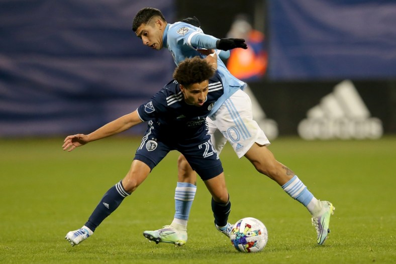 May 7, 2022; New York, NY, New York, NY, USA; Sporting Kansas City midfielder Cameron Duke (28) and. New York City FC midfielder Santiago Rodr guez (20) fight for the ball during the second half at Citi Field. Mandatory Credit: Brad Penner-USA TODAY Sports
