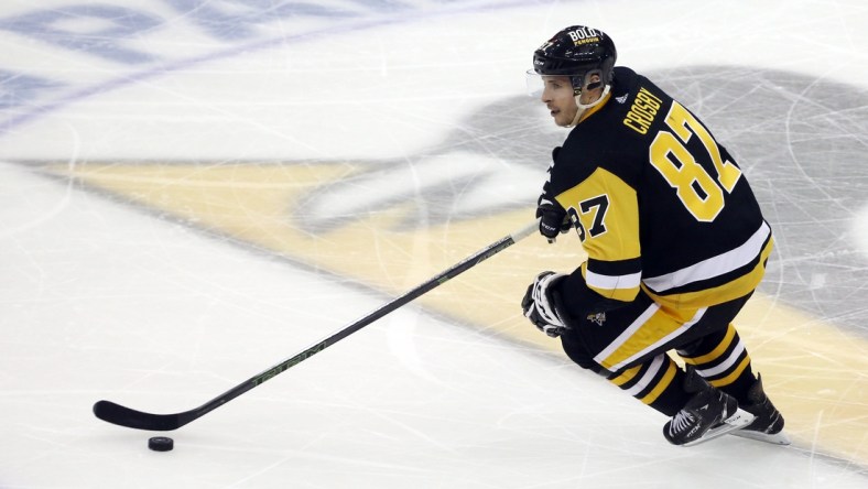 May 7, 2022; Pittsburgh, Pennsylvania, USA; Pittsburgh Penguins center Sidney Crosby (87) skates with the puck against the New York Rangers during the second period in game three of the first round of the 2022 Stanley Cup Playoffs at PPG Paints Arena. The Penguins won 7-4. Mandatory Credit: Charles LeClaire-USA TODAY Sports