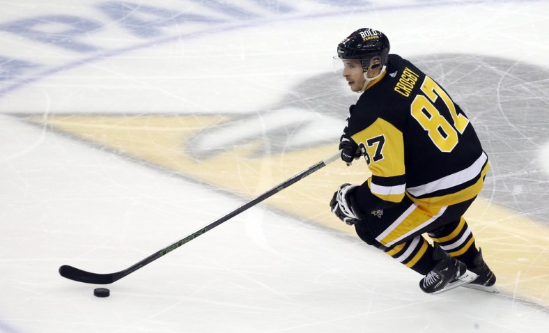 May 7, 2022; Pittsburgh, Pennsylvania, USA; Pittsburgh Penguins center Sidney Crosby (87) skates with the puck against the New York Rangers during the second period in game three of the first round of the 2022 Stanley Cup Playoffs at PPG Paints Arena. The Penguins won 7-4. Mandatory Credit: Charles LeClaire-USA TODAY Sports