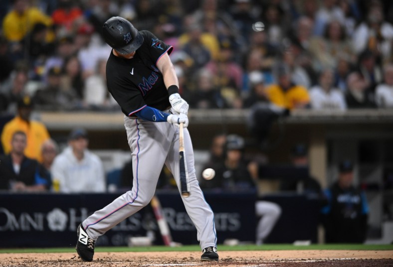 May 7, 2022; San Diego, California, USA; Miami Marlins first baseman Garrett Cooper (26) hits a two-RBI double during the fifth inning against the San Diego Padres at Petco Park. Mandatory Credit: Orlando Ramirez-USA TODAY Sports