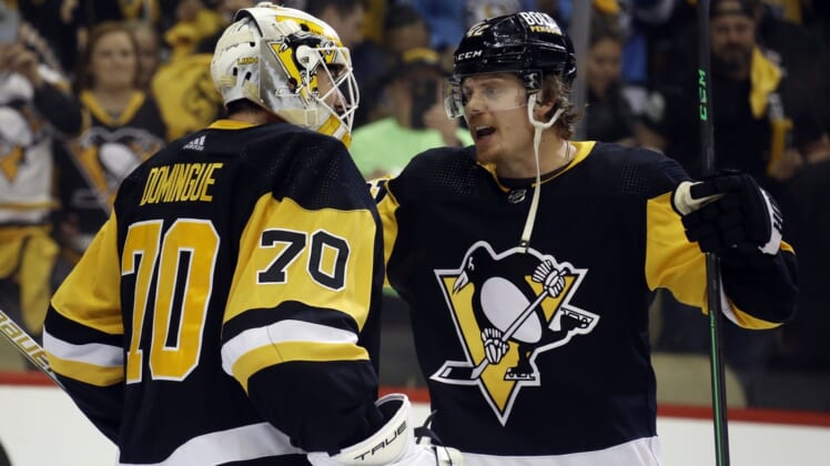 May 7, 2022; Pittsburgh, Pennsylvania, USA; Pittsburgh Penguins goaltender Louis Domingue (70) and right wing Kasperi Kapanen (42) celebrate after defeating the New York Rangers in game three of the first round of the 2022 Stanley Cup Playoffs at PPG Paints Arena. The Penguins won 7-4.  Mandatory Credit: Charles LeClaire-USA TODAY Sports