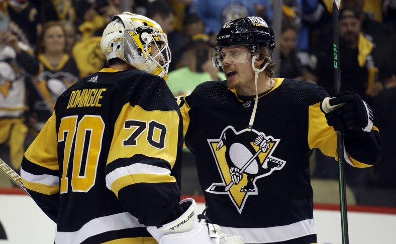 May 7, 2022; Pittsburgh, Pennsylvania, USA; Pittsburgh Penguins goaltender Louis Domingue (70) and right wing Kasperi Kapanen (42) celebrate after defeating the New York Rangers in game three of the first round of the 2022 Stanley Cup Playoffs at PPG Paints Arena. The Penguins won 7-4.  Mandatory Credit: Charles LeClaire-USA TODAY Sports