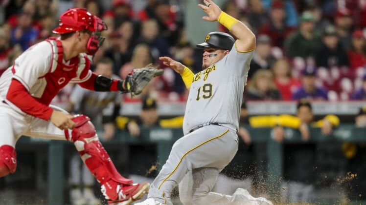 May 7, 2022; Cincinnati, Ohio, USA; Pittsburgh Pirates designated hitter Daniel Vogelbach (19) slides into home on a triple by right fielder Jack Suwinski (not pictured) in the seventh inning against the Cincinnati Reds at Great American Ball Park. Mandatory Credit: Katie Stratman-USA TODAY Sports
