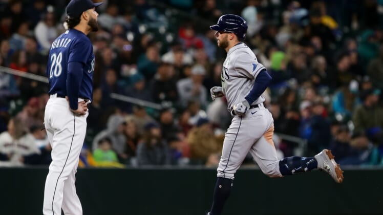 May 7, 2022; Seattle, Washington, USA;  Tampa Bay Rays second baseman Brandon Lowe (8) rounds the bases after hitting a home run as Seattle Mariners third baseman Eugenio Suarez (28) looks on during the sixth inning at T-Mobile Park. Mandatory Credit: Lindsey Wasson-USA TODAY Sports