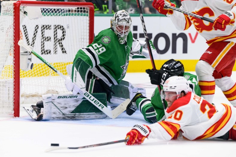 May 7, 2022; Dallas, Texas, USA; Dallas Stars goaltender Jake Oettinger (29) and defenseman Joel Hanley (44) defend against Calgary Flames center Blake Coleman (20) during the second period in game three of the first round of the 2022 Stanley Cup Playoffs at American Airlines Center. Mandatory Credit: Jerome Miron-USA TODAY Sports