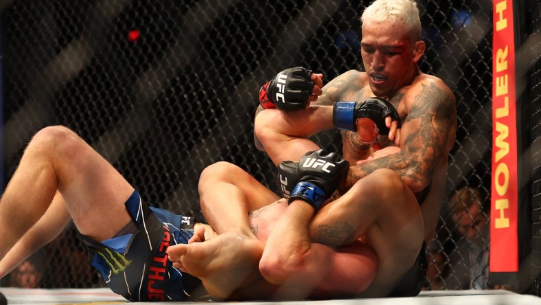 May 7, 2022; Phoenix, Arizona, USA; Charles Oliveira applies a hold against Justin Gaethje during UFC 274 at Footprint Center. Mandatory Credit: Mark J. Rebilas-USA TODAY Sports