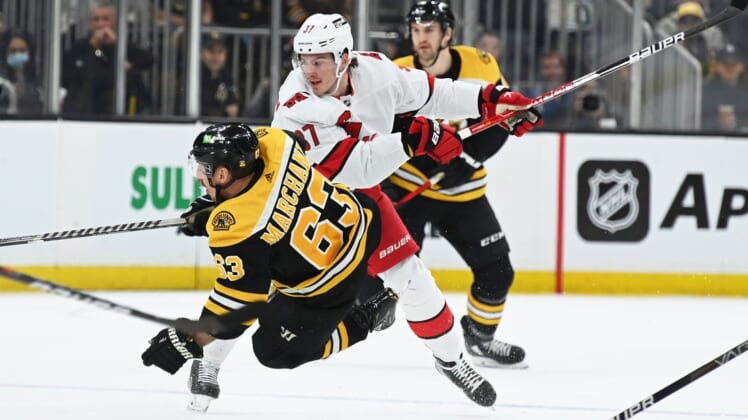May 8, 2022; Boston, Massachusetts, USA; Carolina Hurricanes right wing Andrei Svechnikov (37) checks Boston Bruins left wing Brad Marchand (63) during the first period in game four of the first round of the 2022 Stanley Cup Playoffs at TD Garden. Mandatory Credit: Bob DeChiara-USA TODAY Sports