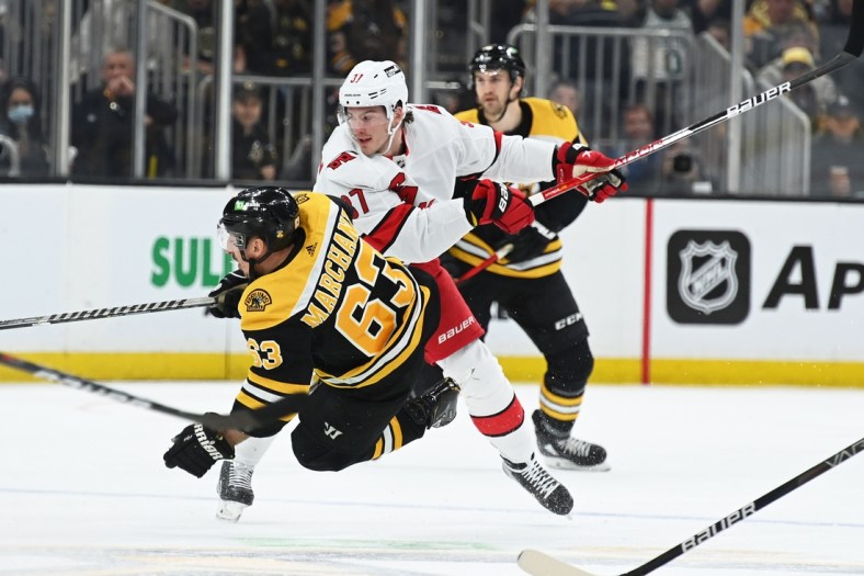 May 8, 2022; Boston, Massachusetts, USA; Carolina Hurricanes right wing Andrei Svechnikov (37) checks Boston Bruins left wing Brad Marchand (63) during the first period in game four of the first round of the 2022 Stanley Cup Playoffs at TD Garden. Mandatory Credit: Bob DeChiara-USA TODAY Sports