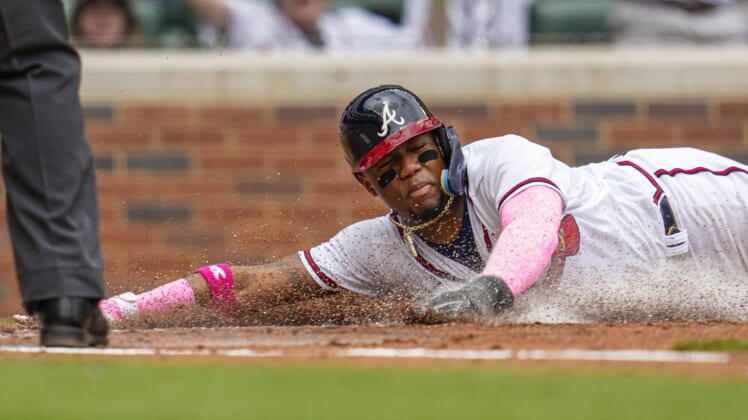 May 8, 2022; Cumberland, Georgia, USA; Atlanta Braves designated hitter Ronald Acuna Jr. (13) slides into home plate to score a run against the Milwaukee Brewers during the second inning at Truist Park. Mandatory Credit: Dale Zanine-USA TODAY Sports