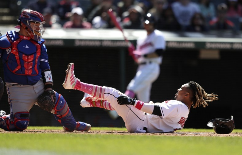 May 8, 2022; Cleveland, Ohio, USA;  Cleveland Guardians Jose Ramirez (11) falls down in front of Toronto Blue Jays catcher Alejandro Kirk (30) after a swing during the fifth inning at Progressive Field. Mandatory Credit: Aaron Josefczyk-USA TODAY Sports