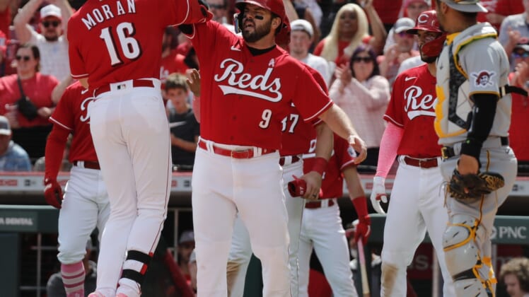 May 8, 2022; Cincinnati, Ohio, USA; Cincinnati Reds first baseman Colin Moran (16) reacts with designated hitter Mike Moustakas (9) after hitting a grand slam against the Pittsburgh Pirates during the sixth inning at Great American Ball Park. Mandatory Credit: David Kohl-USA TODAY Sports