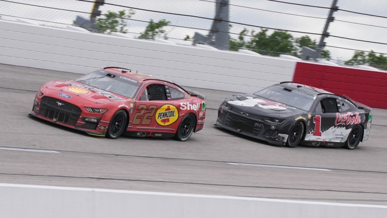 May 8, 2022; Darlington, South Carolina, USA; NASCAR Cup Series driver Joey Logano (22) races NASCAR Cup Series driver Ross Chastain (1) during the Goodyear 400 at Darlington Raceway. Mandatory Credit: Jasen Vinlove-USA TODAY Sports