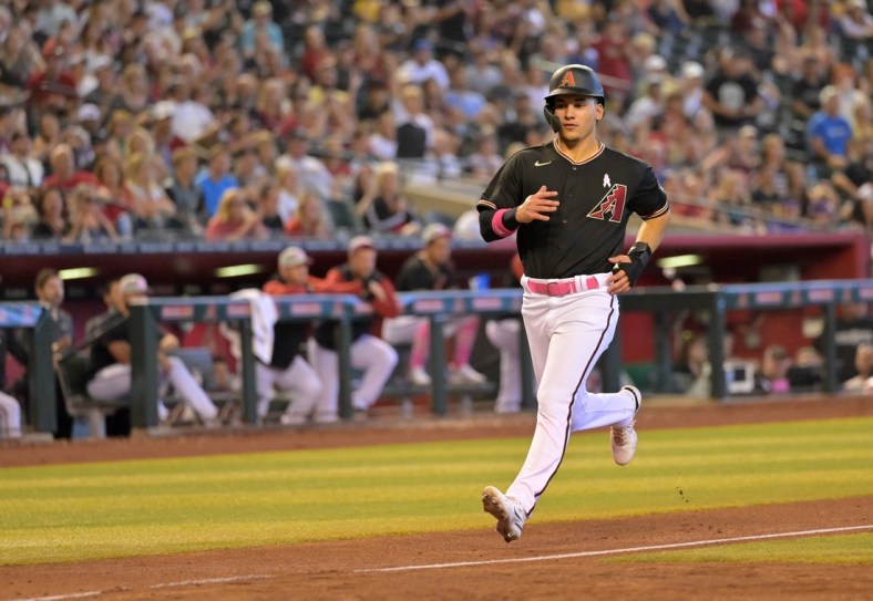 May 8, 2022; Phoenix, Arizona, USA; Arizona Diamondbacks shortstop Alek Thomas (5) scores from third after Colorado Rockies starting pitcher German Marquez (48) overthrew first base on a pickoff attempt in the fifth inning at Chase Field. Mandatory Credit: Jayne Kamin-Oncea-USA TODAY Sports