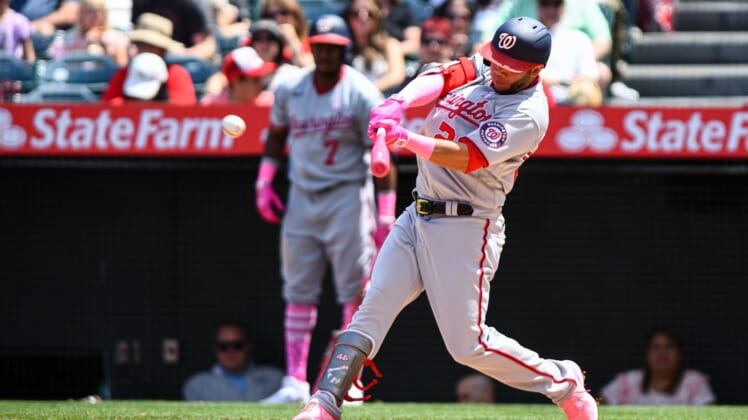 May 8, 2022; Anaheim, California, USA;  Washington Nationals left fielder Yadiel Hernandez (29) hits a single against the Los Angeles Angels during the fourth inning at Angel Stadium. Mandatory Credit: Jonathan Hui-USA TODAY Sports