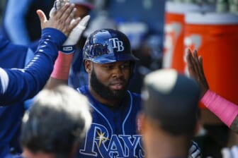 May 8, 2022; Seattle, Washington, USA; Tampa Bay Rays right fielder Manuel Margot (13) exchanges high fives in the dugout after hitting a solo home run against the Seattle Mariners during the eighth inning at T-Mobile Park. Mandatory Credit: Joe Nicholson-USA TODAY Sports
