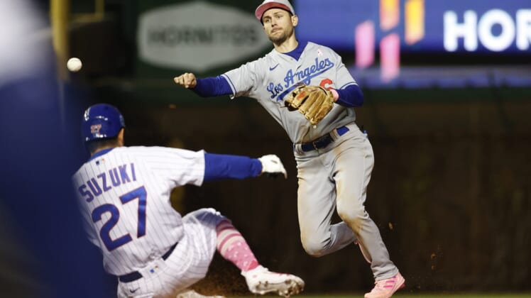 May 8, 2022; Chicago, Illinois, USA; Los Angeles Dodgers shortstop Trea Turner (6) throws out Chicago Cubs right fielder Seiya Suzuki (27) at second base during the sixth inning at Wrigley Field. Mandatory Credit: Kamil Krzaczynski-USA TODAY Sports