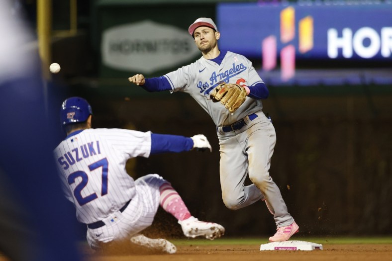 May 8, 2022; Chicago, Illinois, USA; Los Angeles Dodgers shortstop Trea Turner (6) throws out Chicago Cubs right fielder Seiya Suzuki (27) at second base during the sixth inning at Wrigley Field. Mandatory Credit: Kamil Krzaczynski-USA TODAY Sports
