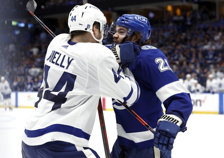 May 8, 2022; Tampa, Florida, USA; Toronto Maple Leafs defenseman Morgan Rielly (44) and Tampa Bay Lightning center Brayden Point (21) fight during the third period of game four of the first round of the 2022 Stanley Cup Playoffs at Amalie Arena. Mandatory Credit: Kim Klement-USA TODAY Sports