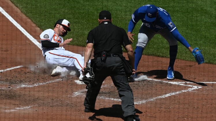 May 9, 2022; Baltimore, Maryland, USA; Baltimore Orioles designated hitter Trey Mancini (16) slides into home plate to score as Kansas City Royals relief pitcher Carlos Hernandez (43) attempts to tag during the fifth inning at Oriole Park at Camden Yards. Mandatory Credit: Tommy Gilligan-USA TODAY Sports