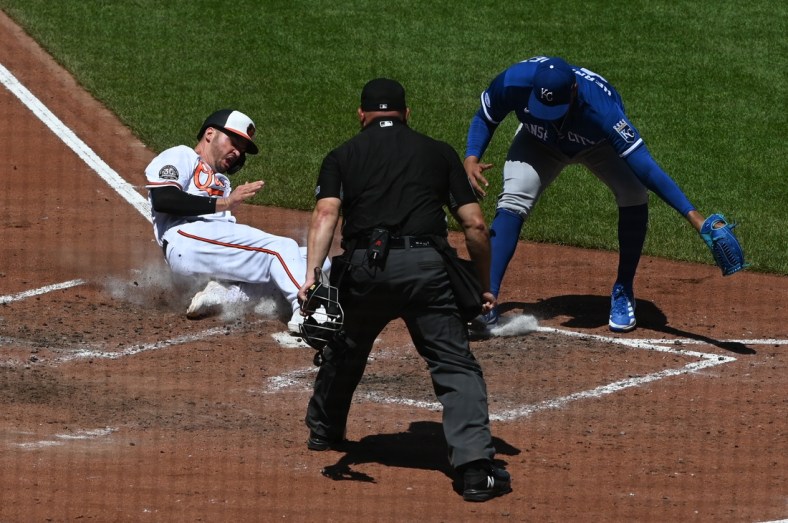 May 9, 2022; Baltimore, Maryland, USA; Baltimore Orioles designated hitter Trey Mancini (16) slides into home plate to score as Kansas City Royals relief pitcher Carlos Hernandez (43) attempts to tag during the fifth inning at Oriole Park at Camden Yards. Mandatory Credit: Tommy Gilligan-USA TODAY Sports