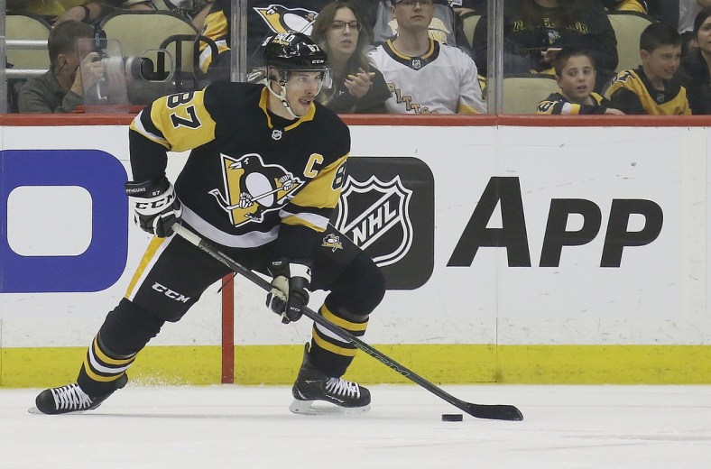 May 9, 2022; Pittsburgh, Pennsylvania, USA;   Pittsburgh Penguins center Sidney Crosby (87) handles the puck against the New York Rangers during the first period in game four of the first round of the 2022 Stanley Cup Playoffs at PPG Paints Arena. Mandatory Credit: Charles LeClaire-USA TODAY Sports