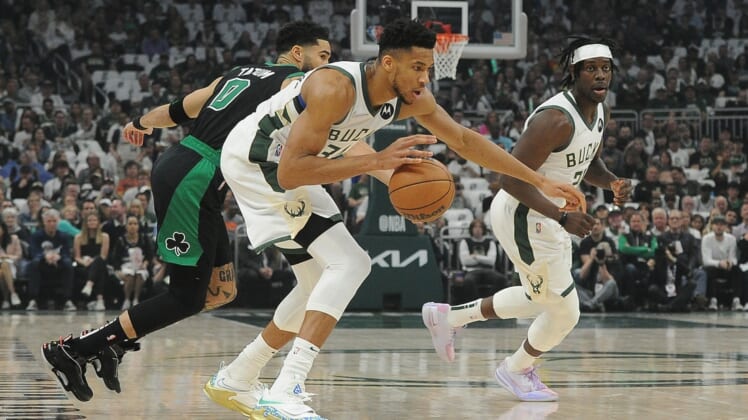 May 9, 2022; Milwaukee, Wisconsin, USA; Milwaukee Bucks forward Giannis Antetokounmpo (34) dribbles the ball against Boston Celtics forward Jayson Tatum (0) in the first half during game four of the second round for the 2022 NBA playoffs at Fiserv Forum. Mandatory Credit: Michael McLoone-USA TODAY Sports