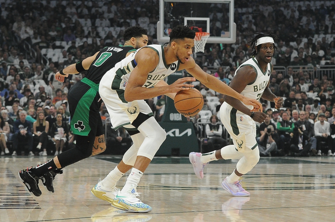 May 9, 2022; Milwaukee, Wisconsin, USA; Milwaukee Bucks forward Giannis Antetokounmpo (34) dribbles the ball against Boston Celtics forward Jayson Tatum (0) in the first half during game four of the second round for the 2022 NBA playoffs at Fiserv Forum. Mandatory Credit: Michael McLoone-USA TODAY Sports