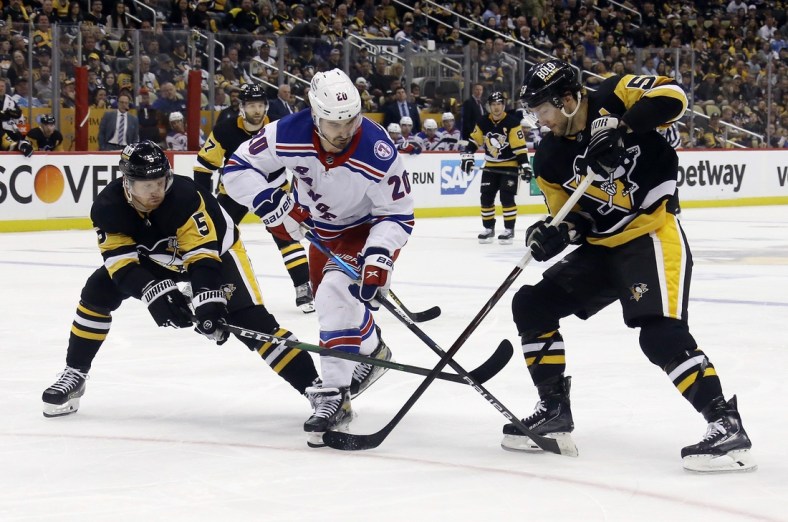 May 9, 2022; Pittsburgh, Pennsylvania, USA;   Pittsburgh Penguins defenseman Mike Matheson (5) and Pittsburgh Penguins defenseman Kris Letang (58) defend New York Rangers left wing Chris Kreider (20) during the third period  in game four of the first round of the 2022 Stanley Cup Playoffs at PPG Paints Arena. The Penguins won 7-2. Mandatory Credit: Charles LeClaire-USA TODAY Sports