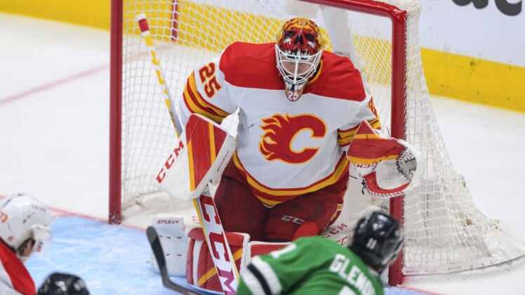 May 9, 2022; Dallas, Texas, USA; Calgary Flames goaltender Jacob Markstrom (25) faces a shot by Dallas Stars center Luke Glendening (11) during the first period in game four of the first round of the 2022 Stanley Cup Playoffs at American Airlines Center. Mandatory Credit: Jerome Miron-USA TODAY Sports