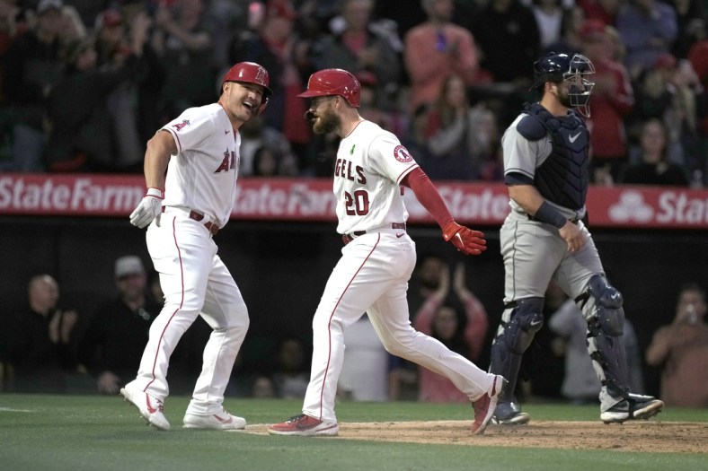 May 9, 2022; Anaheim, California, USA; Los Angeles Angels first baseman Jared Walsh (20) celebrates with center fielder Mike Trout (27) after hitting a three-run home run in the fourth inning as Tampa Bay Rays right fielder Brett Phillips (35) watches at Angel Stadium. Mandatory Credit: Kirby Lee-USA TODAY Sports
