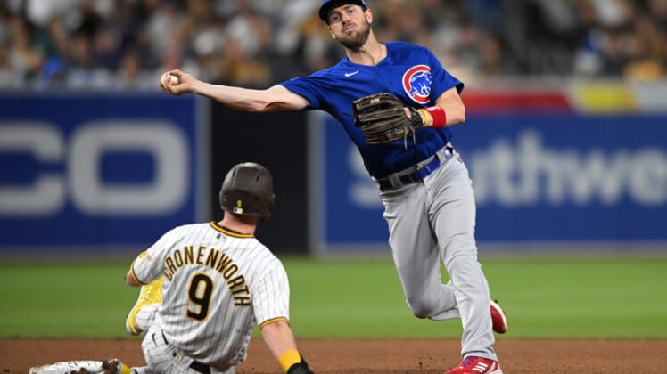 May 9, 2022; San Diego, California, USA; (Editors Notes: Caption Correction) Chicago Cubs third baseman Patrick Wisdom (right) throws to first base late after forcing out San Diego Padres second baseman Jake Cronenworth (9) at second base during the fourth inning at Petco Park. Mandatory Credit: Orlando Ramirez-USA TODAY Sports