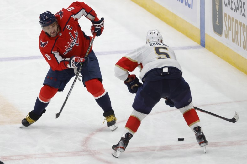 May 9, 2022; Washington, District of Columbia, USA; Washington Capitals left wing Alex Ovechkin (8) attempts to skate with the puck around Florida Panthers defenseman Aaron Ekblad (5) in the third period in game four of the first round of the 2022 Stanley Cup Playoffs at Capital One Arena. Mandatory Credit: Geoff Burke-USA TODAY Sports
