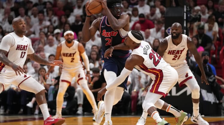 May 10, 2022; Miami, Florida, USA; Miami Heat forward Jimmy Butler (22) battles Philadelphia 76ers center Joel Embiid (21) for the ball during the second half in game five of the second round for the 2022 NBA playoffs at FTX Arena. Mandatory Credit: Jasen Vinlove-USA TODAY Sports