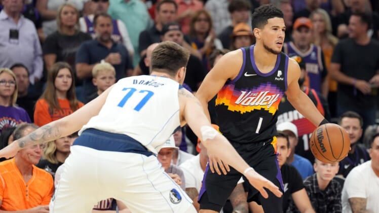 May 10, 2022; Phoenix, Arizona, USA; Phoenix Suns guard Devin Booker (1) dribbles against Dallas Mavericks guard Luka Doncic (77) during the first half of game five of the second round for the 2022 NBA playoffs at Footprint Center. Mandatory Credit: Joe Camporeale-USA TODAY Sports