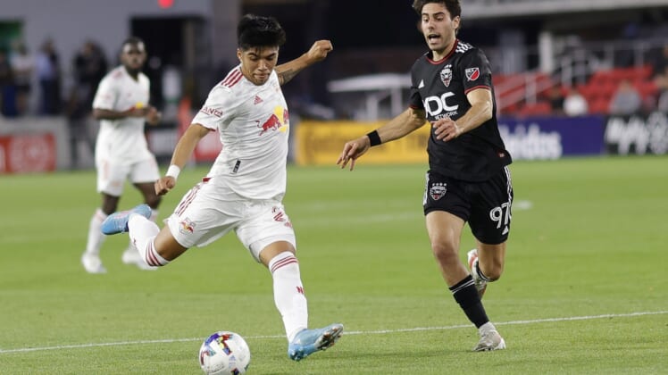 May 10, 2022; Washington, DC, USA; New York Red Bulls midfielder Omir Fernandez (21) shoots the ball as D.C. United midfielder Guediri (97) defends the first half in a US Open Cup match at Audi Field. Mandatory Credit: Geoff Burke-USA TODAY Sports