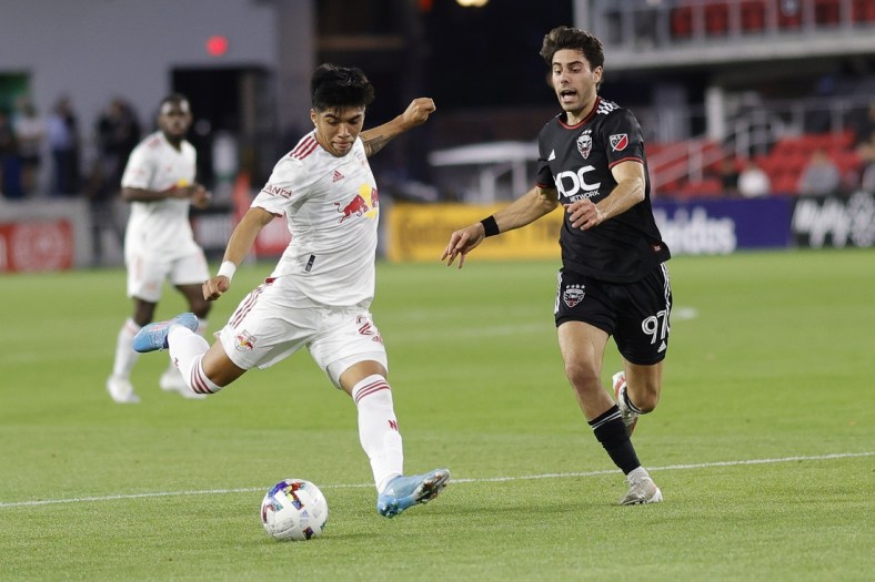 May 10, 2022; Washington, DC, USA; New York Red Bulls midfielder Omir Fernandez (21) shoots the ball as D.C. United midfielder Guediri (97) defends the first half in a US Open Cup match at Audi Field. Mandatory Credit: Geoff Burke-USA TODAY Sports