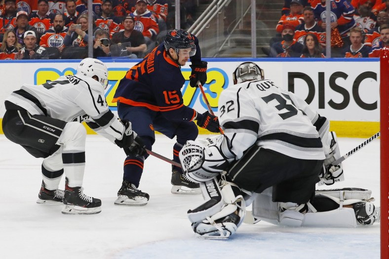 May 10, 2022; Edmonton, Alberta, CAN; Los Angeles Kings goaltender Jonathan Quick (32) makes a save on Edmonton Oilers forward Josh Archibald (15) during the first period in game five of the first round of the 2022 Stanley Cup Playoffs at Rogers Place. Mandatory Credit: Perry Nelson-USA TODAY Sports