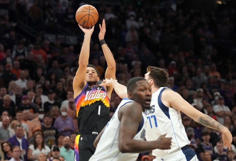 May 10, 2022; Phoenix, Arizona, USA; Phoenix Suns guard Devin Booker (1) shoots against Dallas Mavericks guard Luka Doncic (77) during the first half of game five of the second round for the 2022 NBA playoffs at Footprint Center. Mandatory Credit: Joe Camporeale-USA TODAY Sports