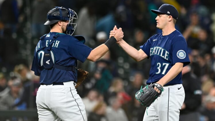 May 10, 2022; Seattle, Washington, USA; Seattle Mariners catcher Luis Torrens (22) and relief pitcher Paul Sewald (37) celebrate after defeating the Philadelphia Phillies at T-Mobile Park. Seattle defeated Philadelphia 5-4. Mandatory Credit: Steven Bisig-USA TODAY Sports