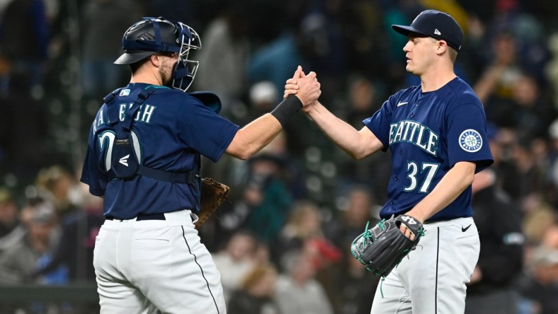 May 10, 2022; Seattle, Washington, USA; Seattle Mariners catcher Luis Torrens (22) and relief pitcher Paul Sewald (37) celebrate after defeating the Philadelphia Phillies at T-Mobile Park. Seattle defeated Philadelphia 5-4. Mandatory Credit: Steven Bisig-USA TODAY Sports