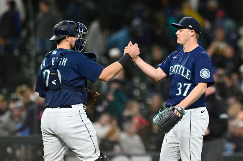 May 10, 2022; Seattle, Washington, USA; Seattle Mariners catcher Luis Torrens (22) and relief pitcher Paul Sewald (37) celebrate after defeating the Philadelphia Phillies at T-Mobile Park. Seattle defeated Philadelphia 5-4. Mandatory Credit: Steven Bisig-USA TODAY Sports