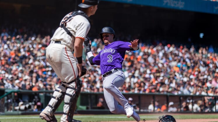 May 11, 2022; San Francisco, California, USA;  Colorado Rockies catcher Dom Nunez (3) slides home to score against San Francisco Giants catcher Joey Bart (21) during the sixth inning at Oracle Park. Mandatory Credit: John Hefti-USA TODAY Sports