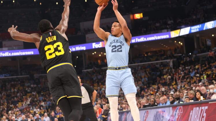 May 11, 2022; Memphis, Tennessee, USA; Memphis Grizzlies guard Desmond Bane (22) shoots the ball over Golden State Warriors forward Draymond Green (23) during game five of the second round for the 2022 NBA playoffs at FedExForum. Mandatory Credit: Joe Rondone-USA TODAY Sports