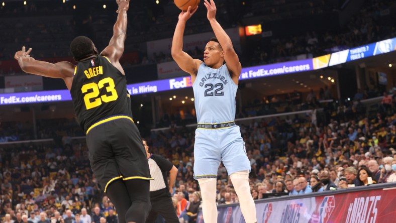 May 11, 2022; Memphis, Tennessee, USA; Memphis Grizzlies guard Desmond Bane (22) shoots the ball over Golden State Warriors forward Draymond Green (23) during game five of the second round for the 2022 NBA playoffs at FedExForum. Mandatory Credit: Joe Rondone-USA TODAY Sports