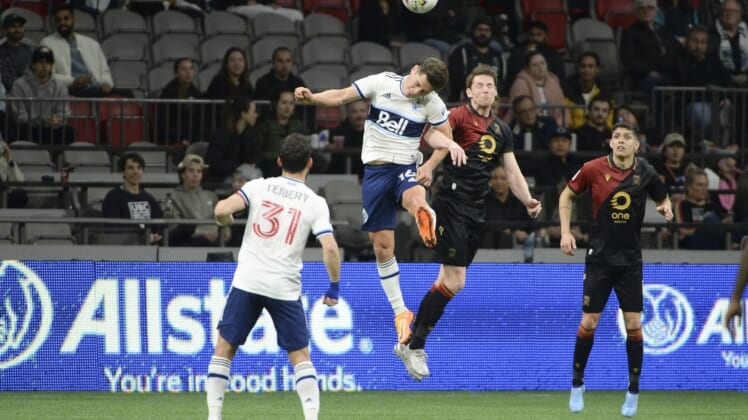 May 11, 2022; Vancouver, British Columbia, Canada;  Vancouver Whitecaps midfielder Sebastian Berhalter (16) goes up for a header against Valour FC forward Daryl Fordyce (16) during the second half at BC Place. Mandatory Credit: Anne-Marie Sorvin-USA TODAY Sports